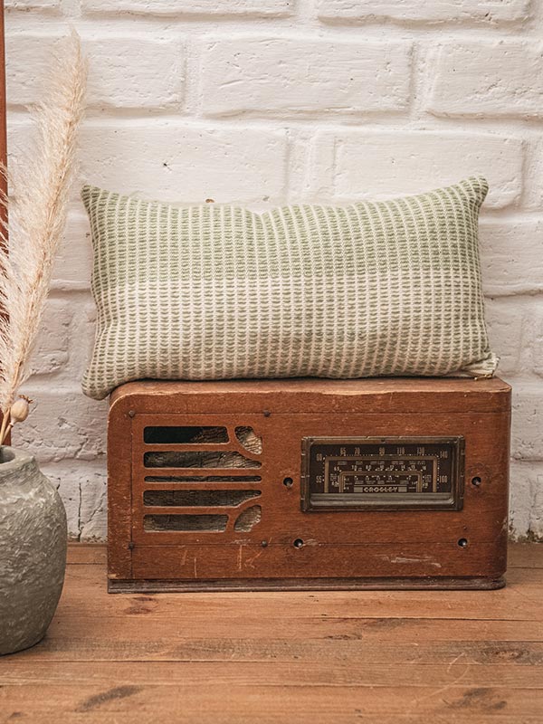 green and white woven textured lumbar cushion