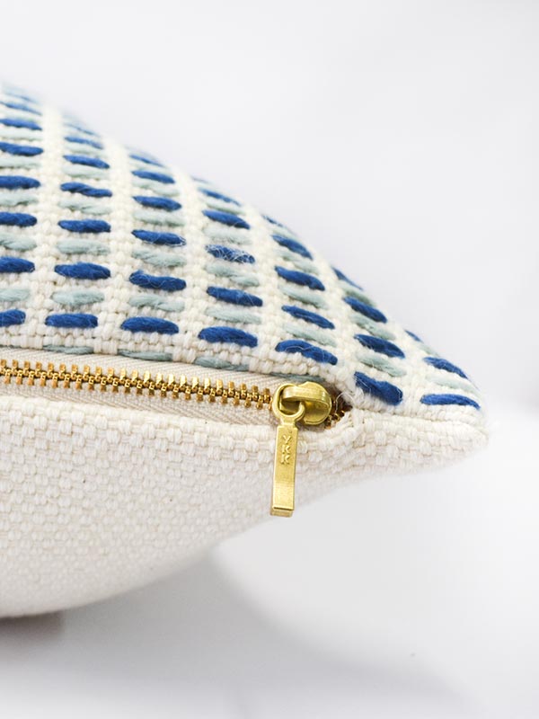 artisan made texture cream and blue accent cushion