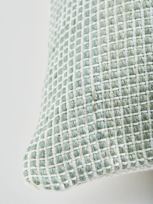 textured sage green and white cushion