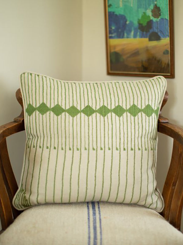 refugee artisan made cushion with green stripes