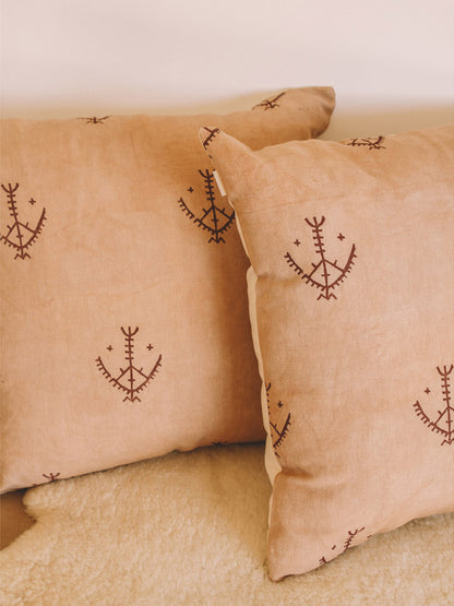 earth brown cushions with hand printed symbols